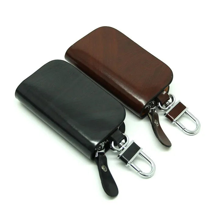 Genuine leather car key case in frost black and brown, showing soft cowhide material and size.