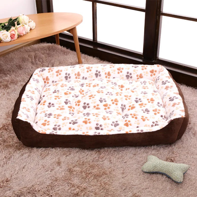Beige plush sofa-style pet bed for a small dog, showing bolstered sides and padded construction.