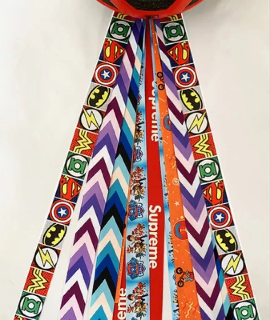 Close-up of a colourful decorative ribbon streamer attached to a child's helmet for roller skating or skiing.