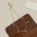 Zircon geometric necklace, earrings, and anklet set with meteor shower detail on a white background.