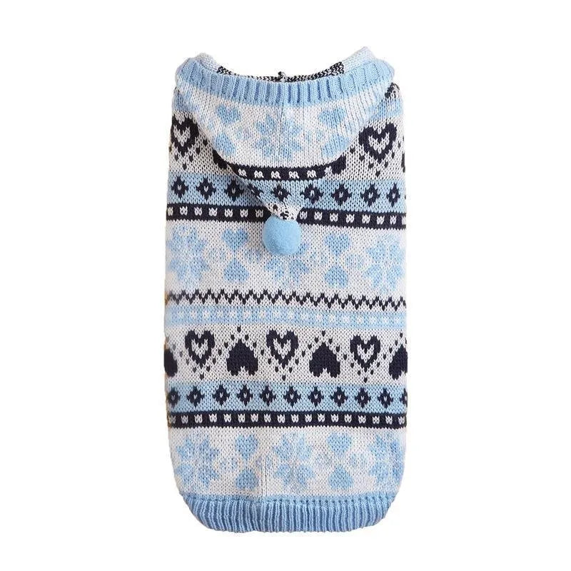 Pink knitted dog jumper with snowflake, love heart, and striped camouflage pattern on a small white dog.