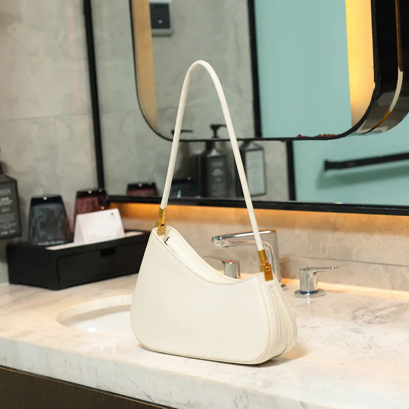 Retro oval women's underarm handbag in multiple colours, showing sandwich pocket design and single shoulder strap.