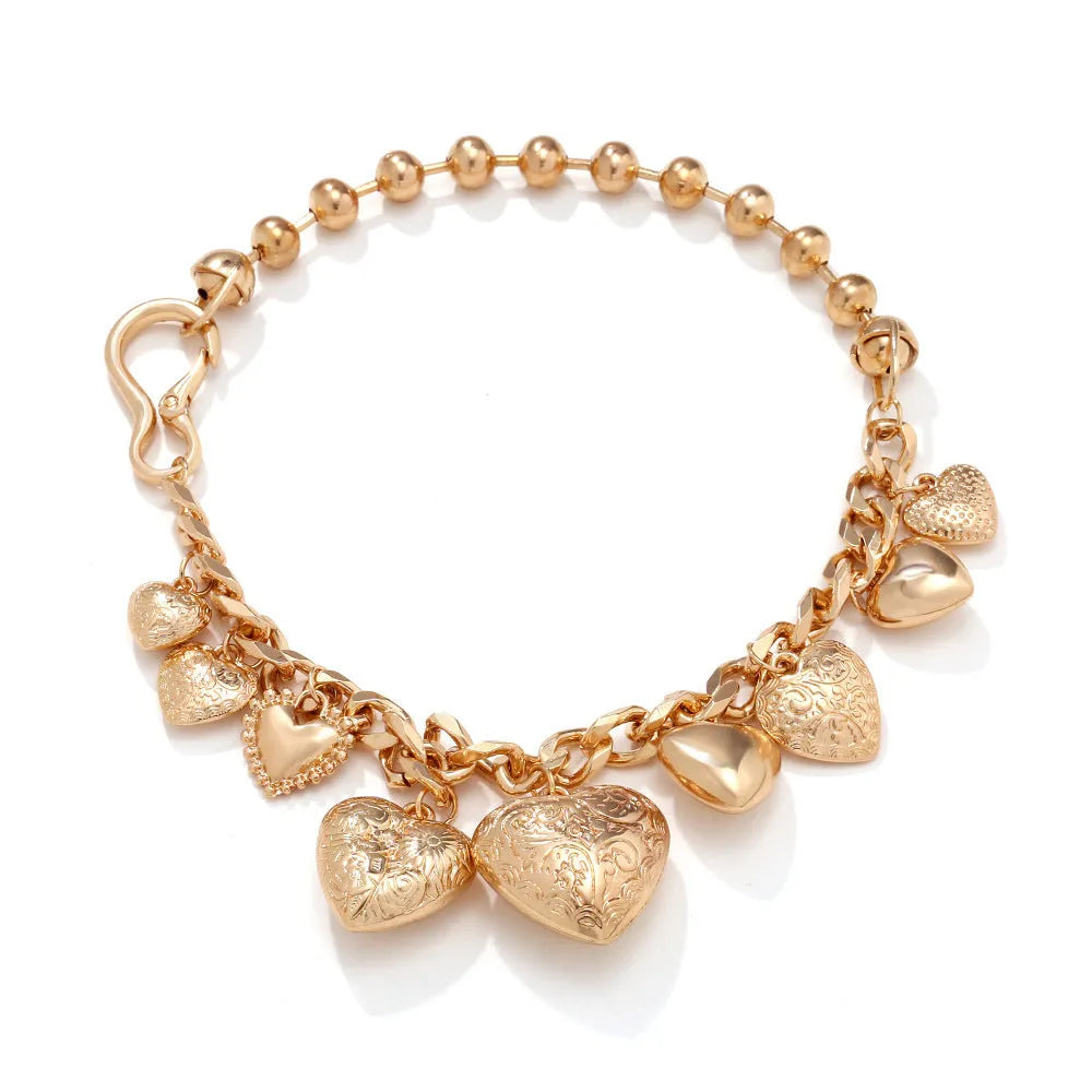 Gold carved heart pendant necklace with adjustable chain on white background