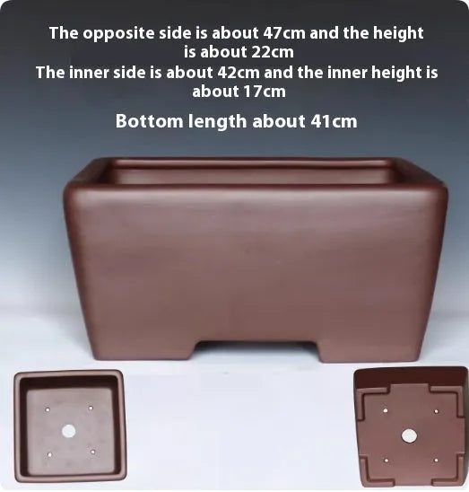 A square purple clay flower pot for succulents or bonsai plants on a tabletop.