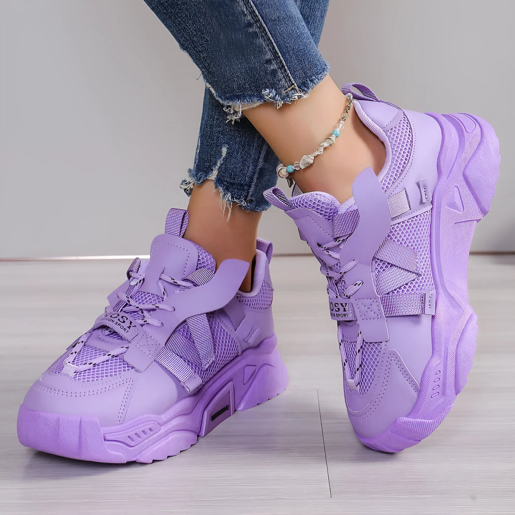 Women's purple platform mesh sports sneakers with animal pattern and lace-up front.