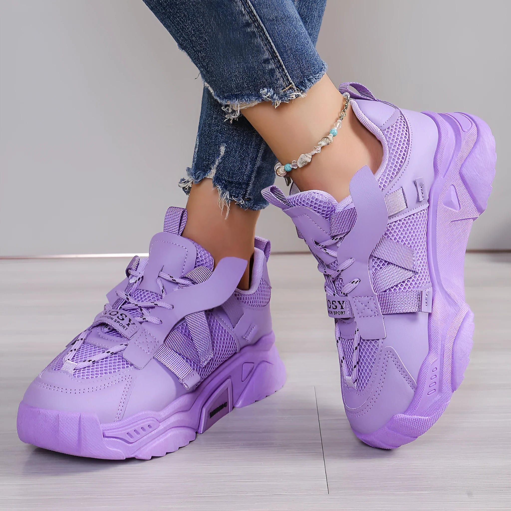 Women's purple platform mesh sports sneakers with animal pattern and lace-up front.