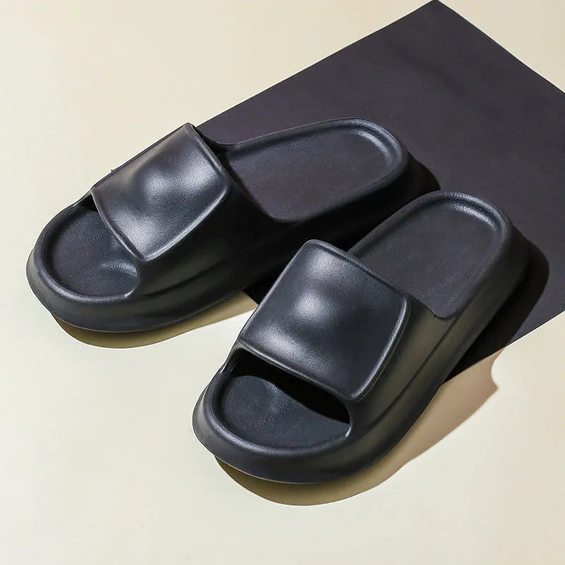 Pair of thick-soled EVA flip flop slippers in purple, showing deep sole profile.