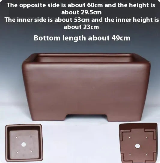A square purple clay flower pot for succulents or bonsai plants on a tabletop.