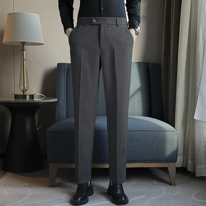 Men's straight leg brown corduroy trousers with an elasticated waistband on a hanger
