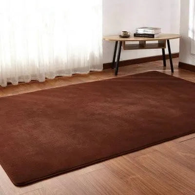 Solid colour plush area rug with non-slip dot-patterned bottom in rectangular shape