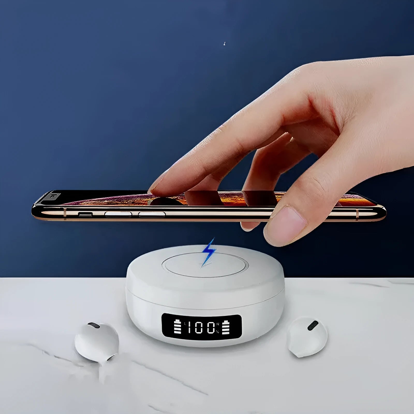 Mini black semi-in-ear wireless headphones sitting inside their white wireless charging case.