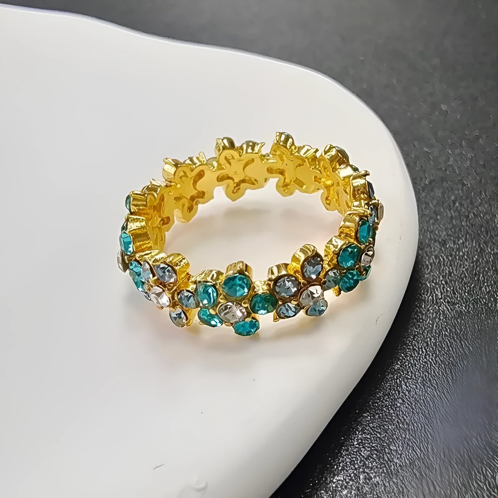 A close-up of a detailed alloy elephant ring with sparkling diamond accents on a gold or silver electroplated band.