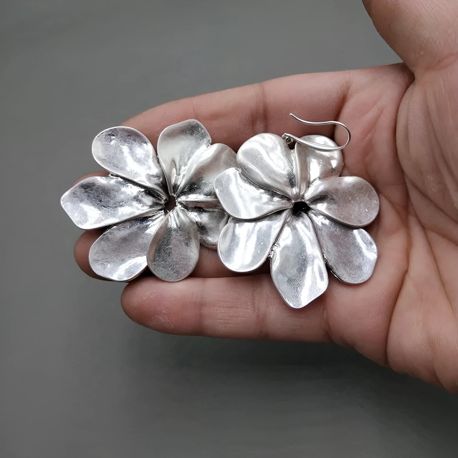 Vintage-style distressed leaf earrings for women in alloy, original silver colour finish on a plain background