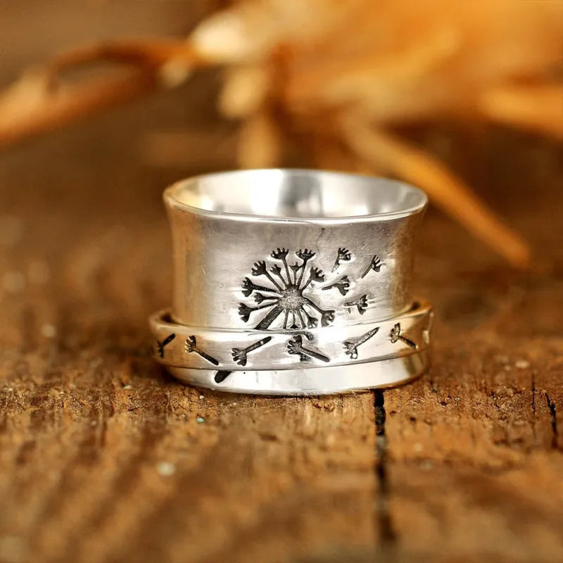 Silver rotatable flower fashion ring showing adjustable floral element and band