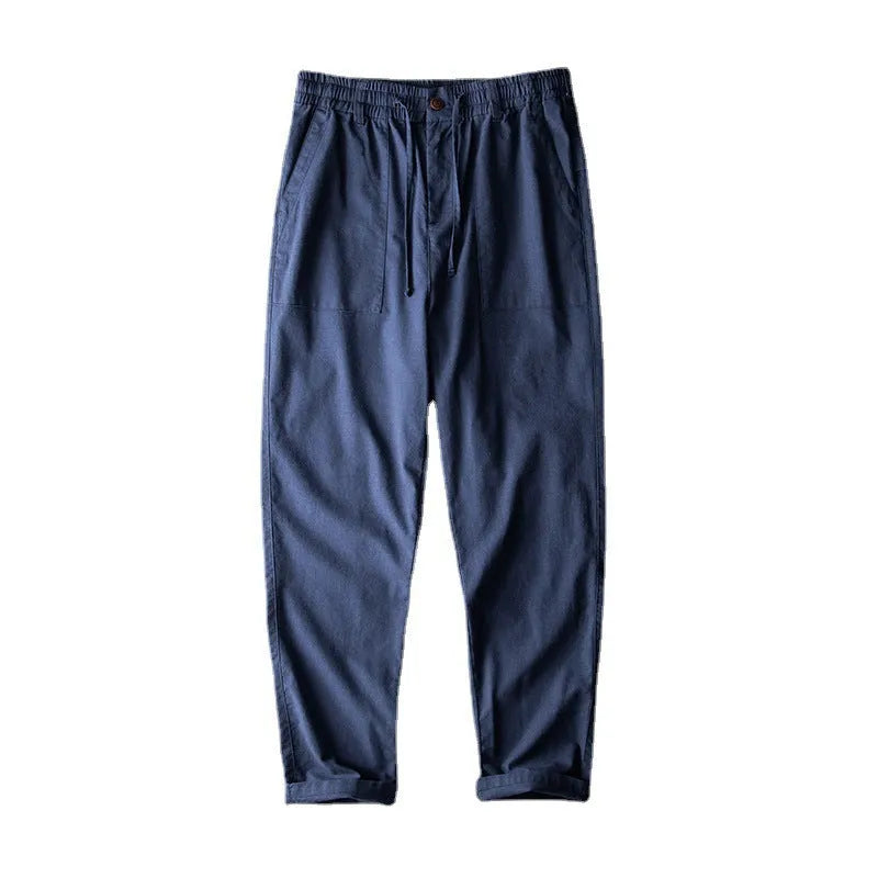 Men's mid waist linen trousers in solid colours showing trousers length and casual styling