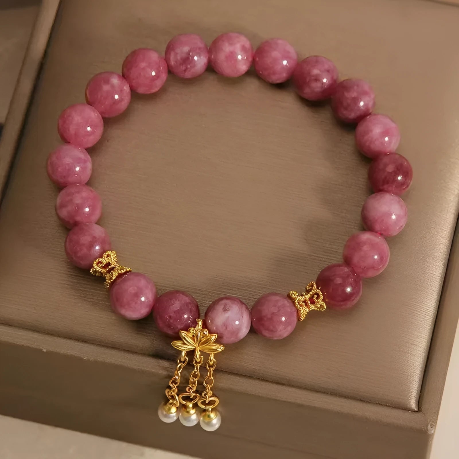 Women's natural stone bracelet with pearl pendant and pink lotus tassel on wrist