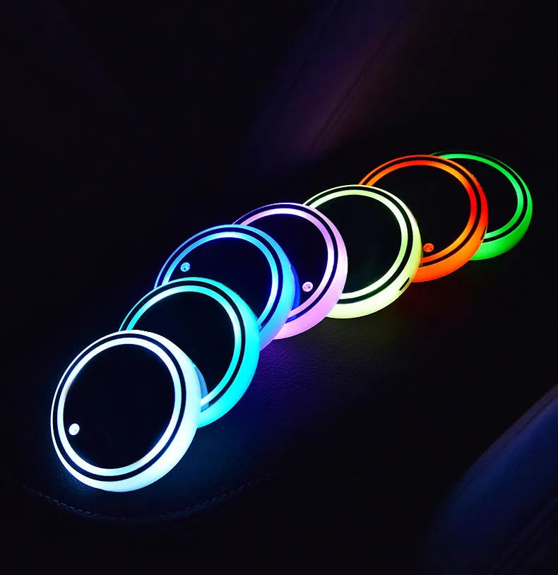 Colourful LED light-up coaster for car cup holder showing seven light colours and USB cable.