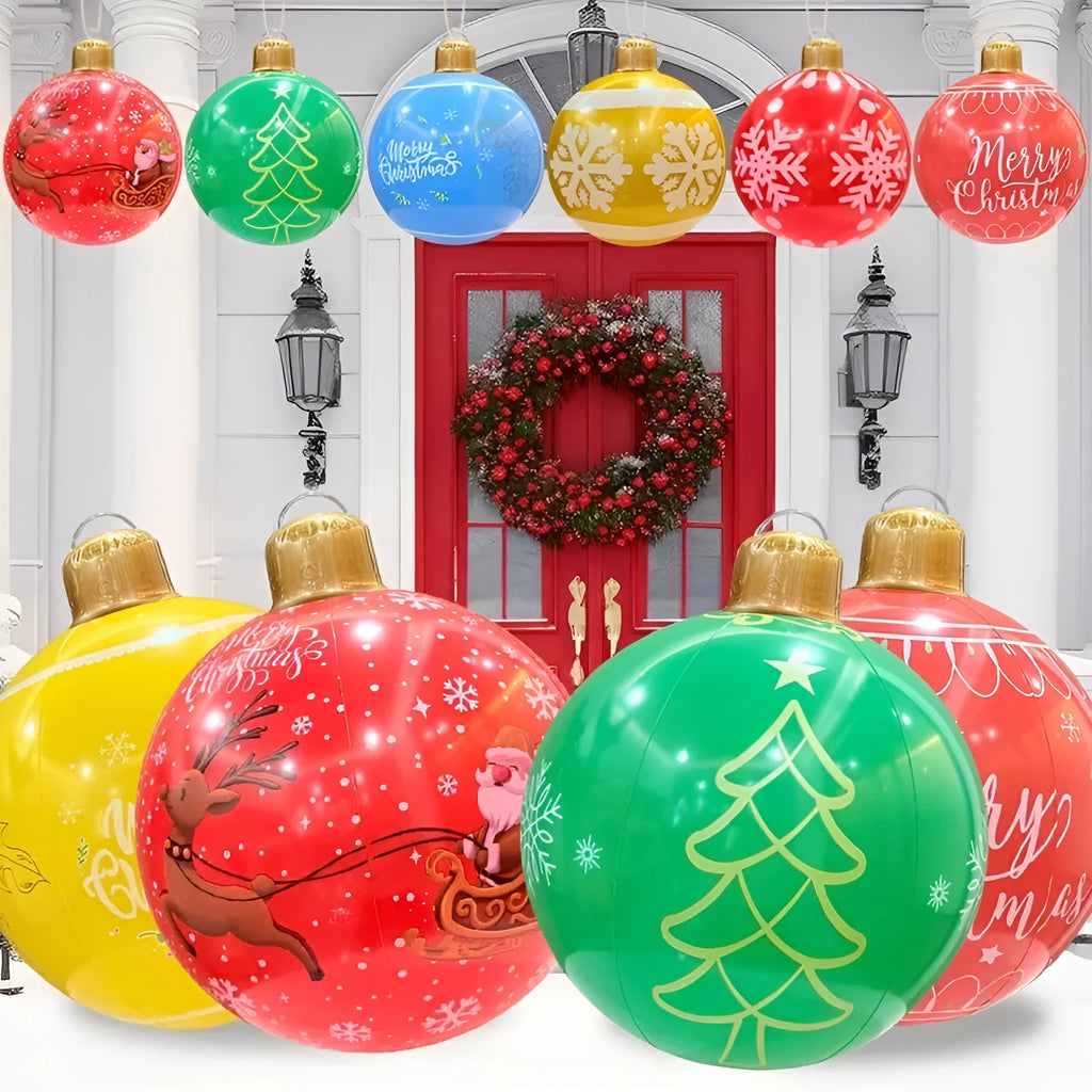 Large red inflatable Christmas ball with snowflake design and LED lights in outdoor garden setting