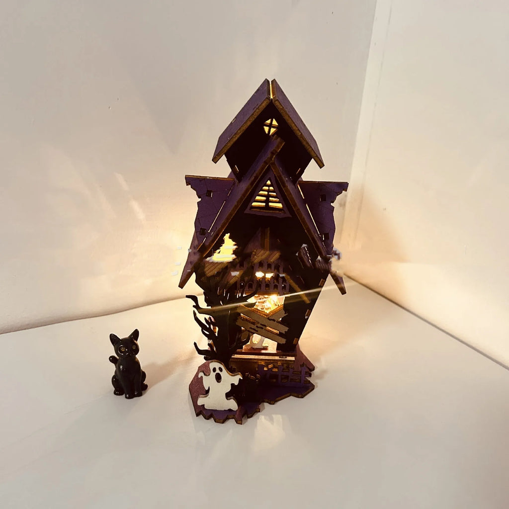 Wooden DIY Halloween haunted house table decoration with glow-in-the-dark details, shown unpainted.