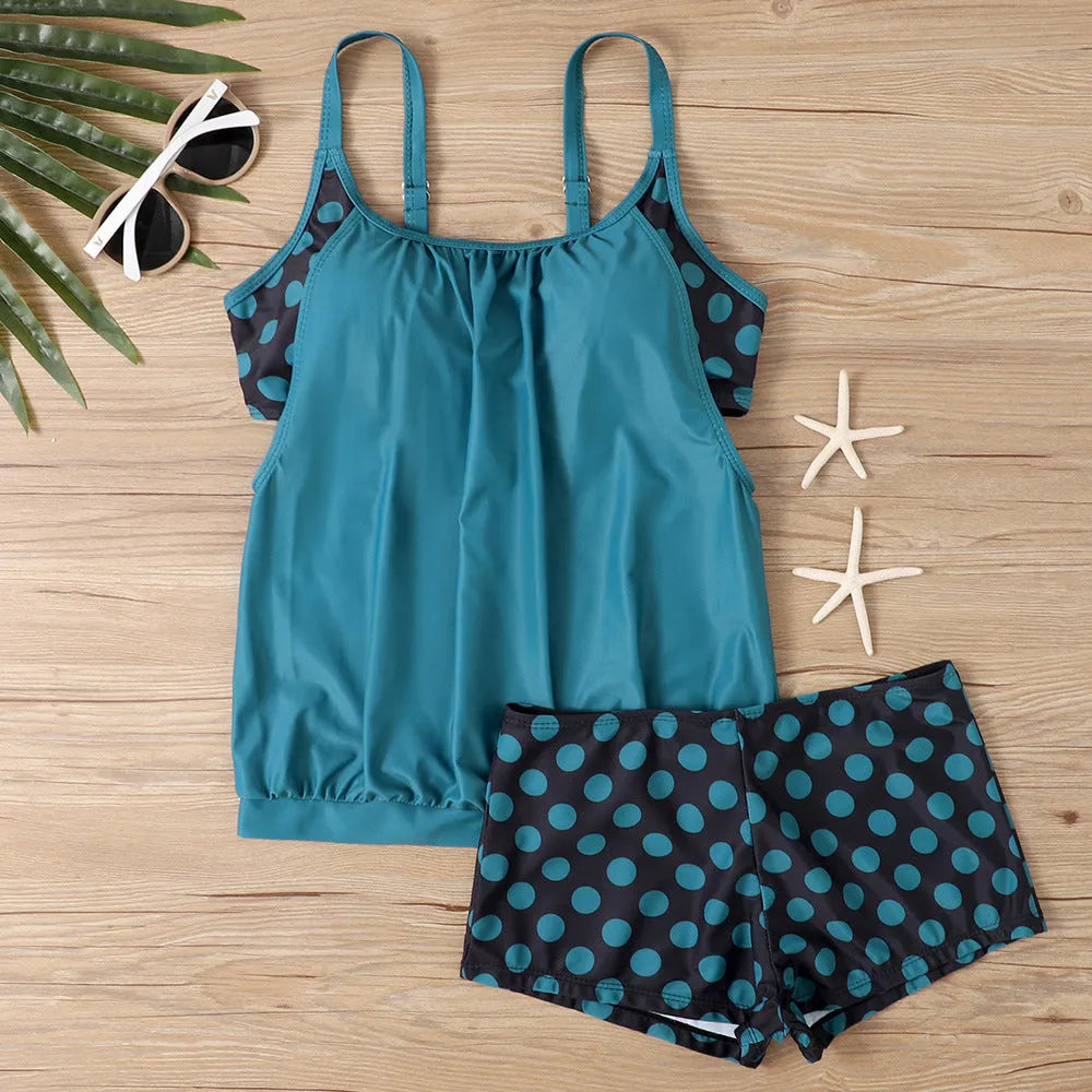 Women's black polka dot boxer swimsuit with high-waisted briefs, made from polyester fabric.