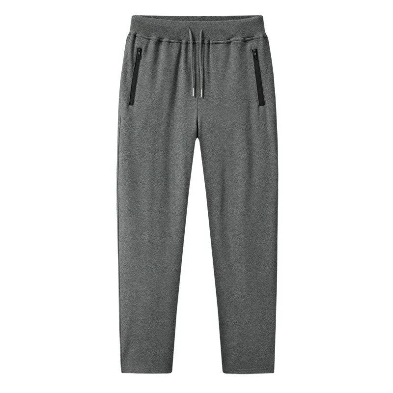 Men's thin leisure tapered knitted pants in black with ankle tie, standing on a neutral background