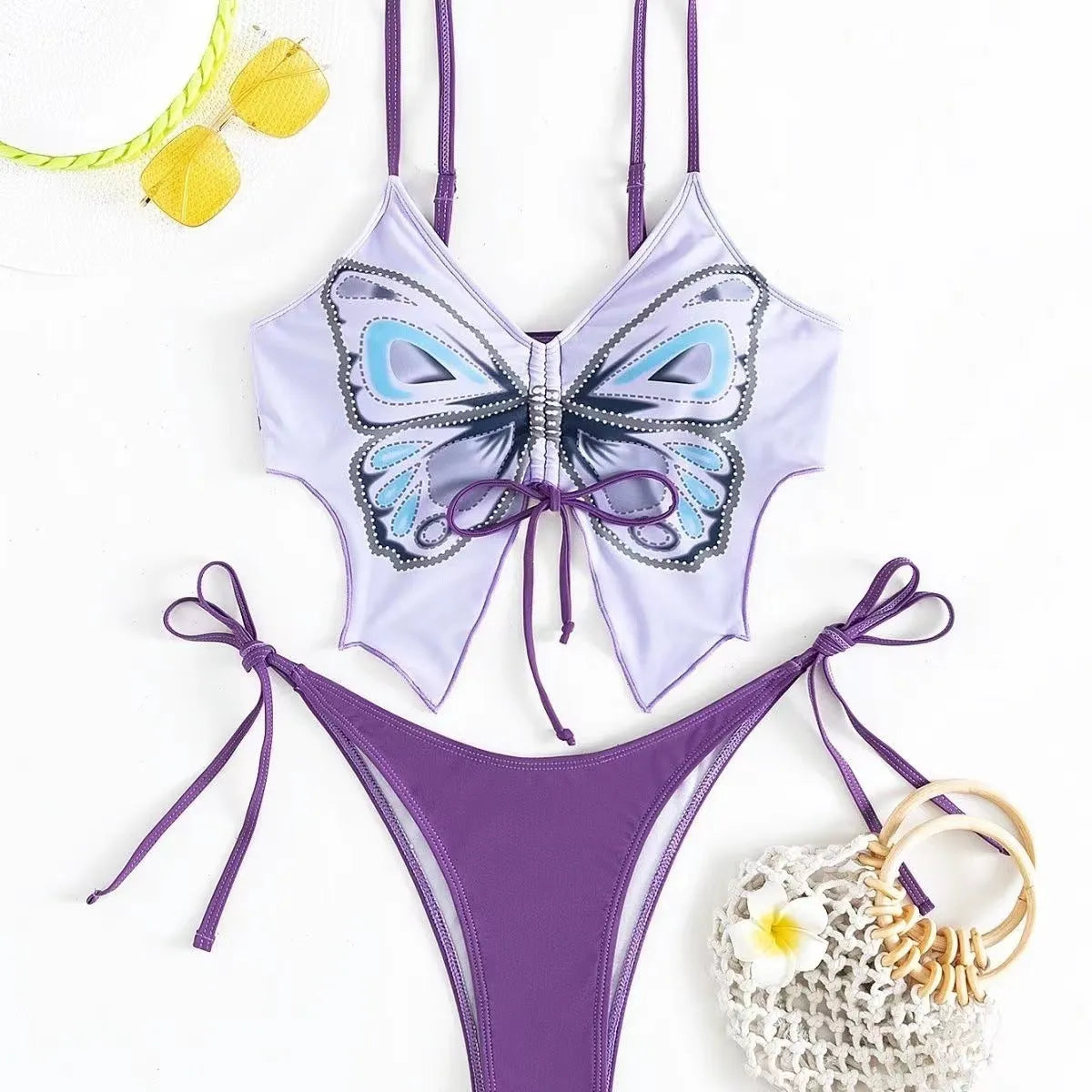 Women's purple bow style split bikini swimsuit with sleeveless top and briefs.