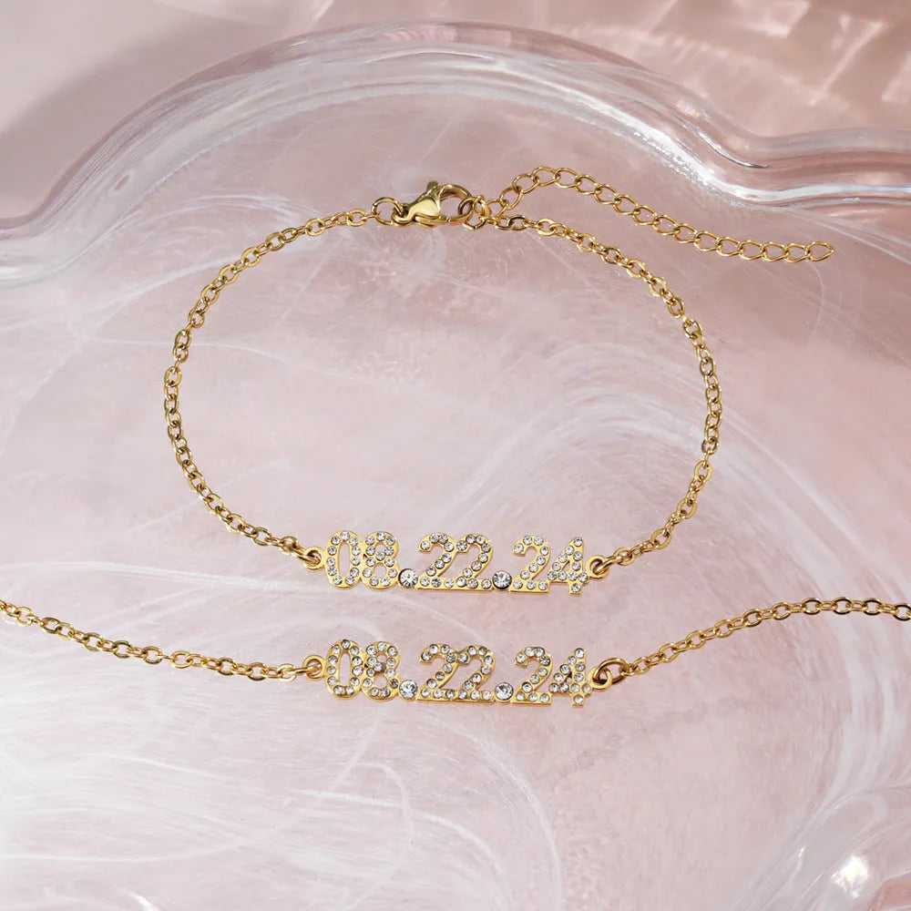 Stainless steel digital bracelet with diamond numerals on a metallic background.