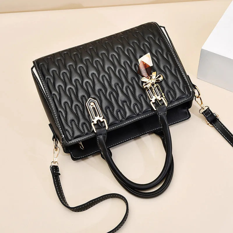 Women's large polyester messenger bag in black with shoulder strap and external pockets.