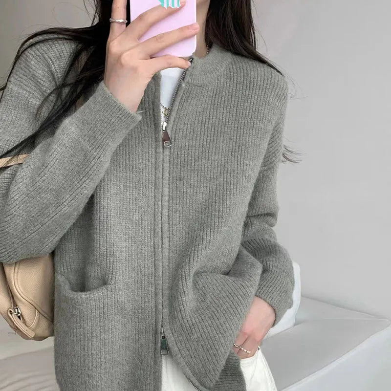 Beige viscose fibre soft wind cardigan coat with long sleeves on a hanger.