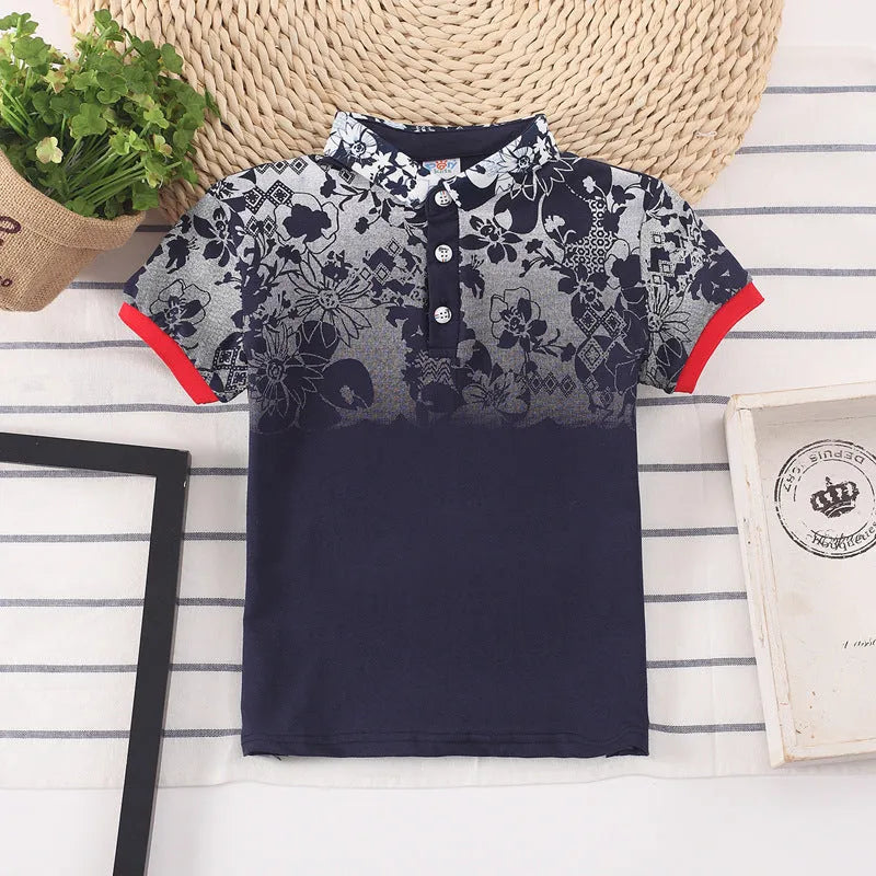 Boys short sleeve cotton T-shirt in navy blue with a lapel collar, laid flat.