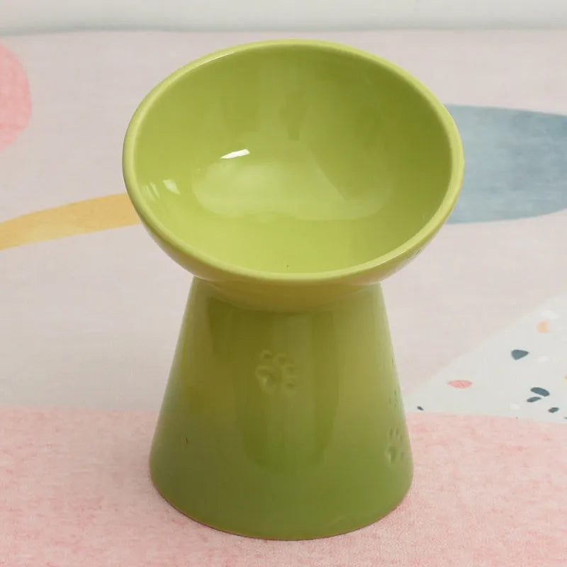 A white ceramic pet bowl with a high foot and raised neck protector to prevent tipping.